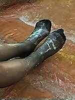 A sexy brunette relishes the warmth of sun on nylon before cooling in water