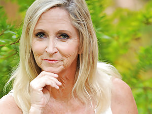 Hot grandma takes off all of her clothes in the garden