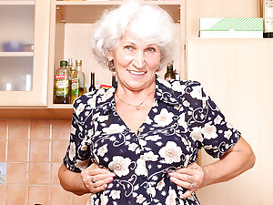 Grey haired grandma fucks her hairy twat with a toy after making cookies